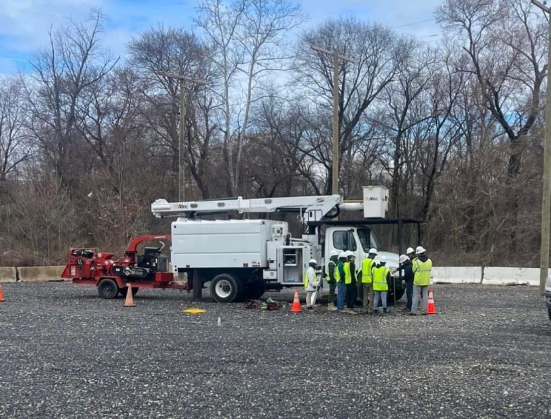 A Mid Atlantic Lineman crew working from a bucket truck on a utility construction job
