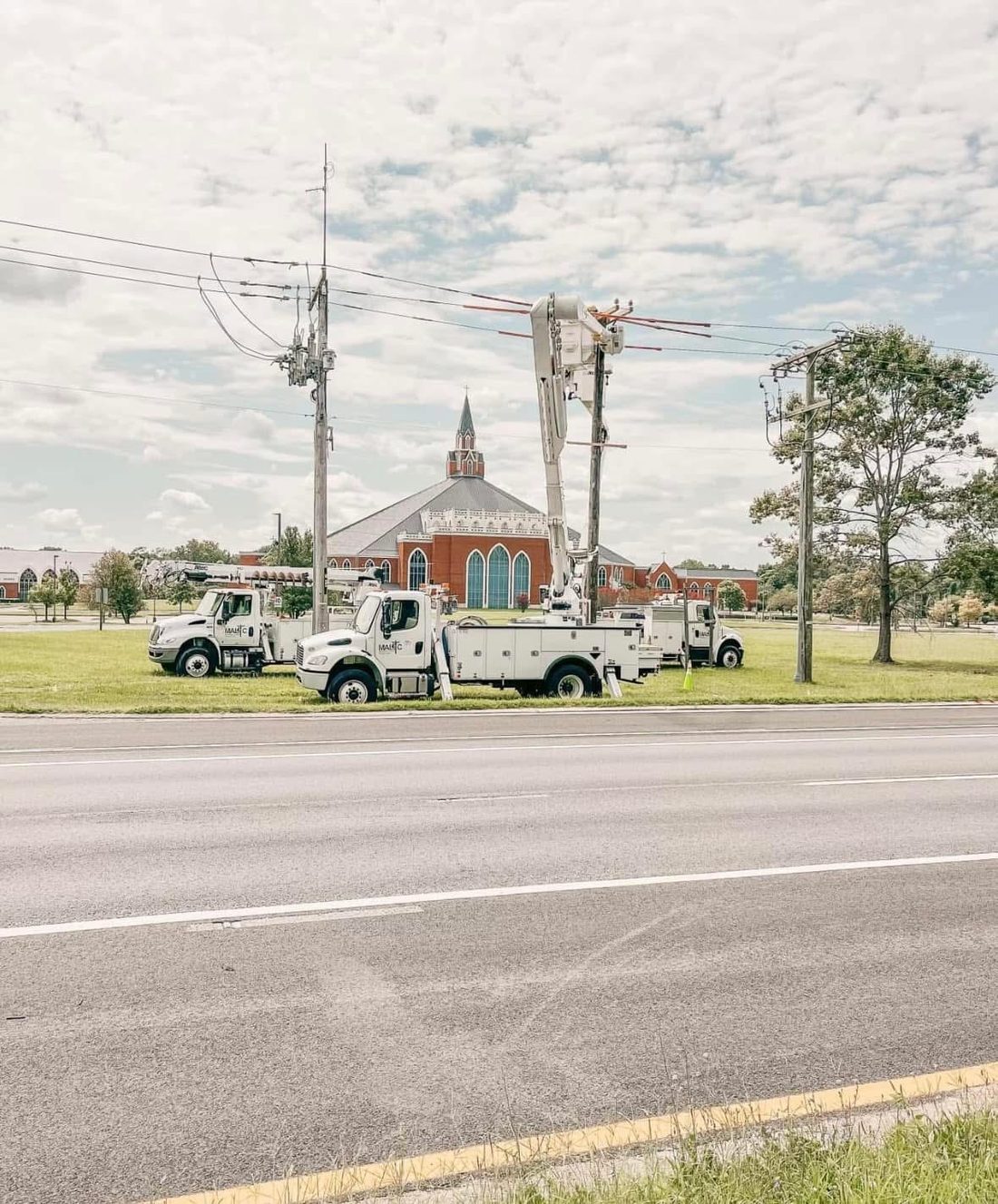A lineman working energized distribution lines from an aerial bucket